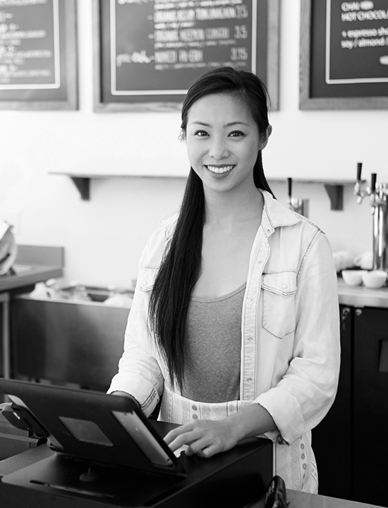 Small business Asian girl at the register of her coffee shop